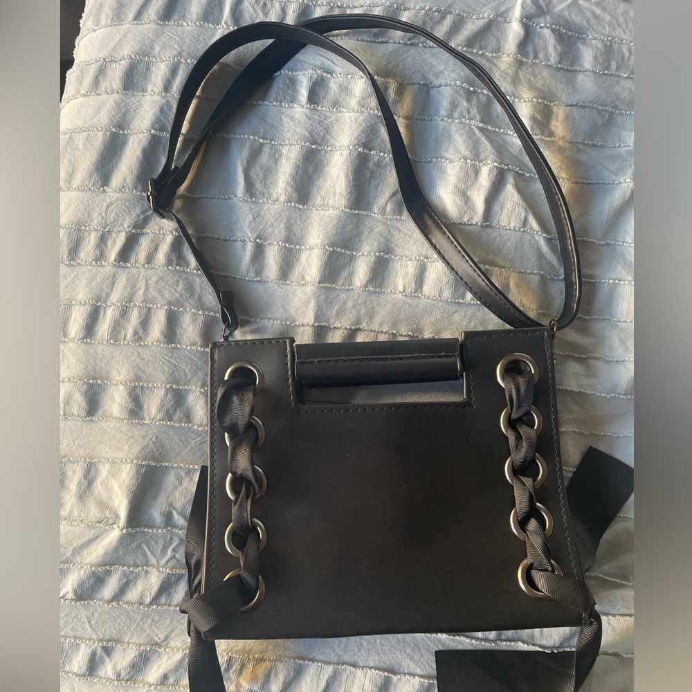 Women’s cross body adjustable strap black bag.